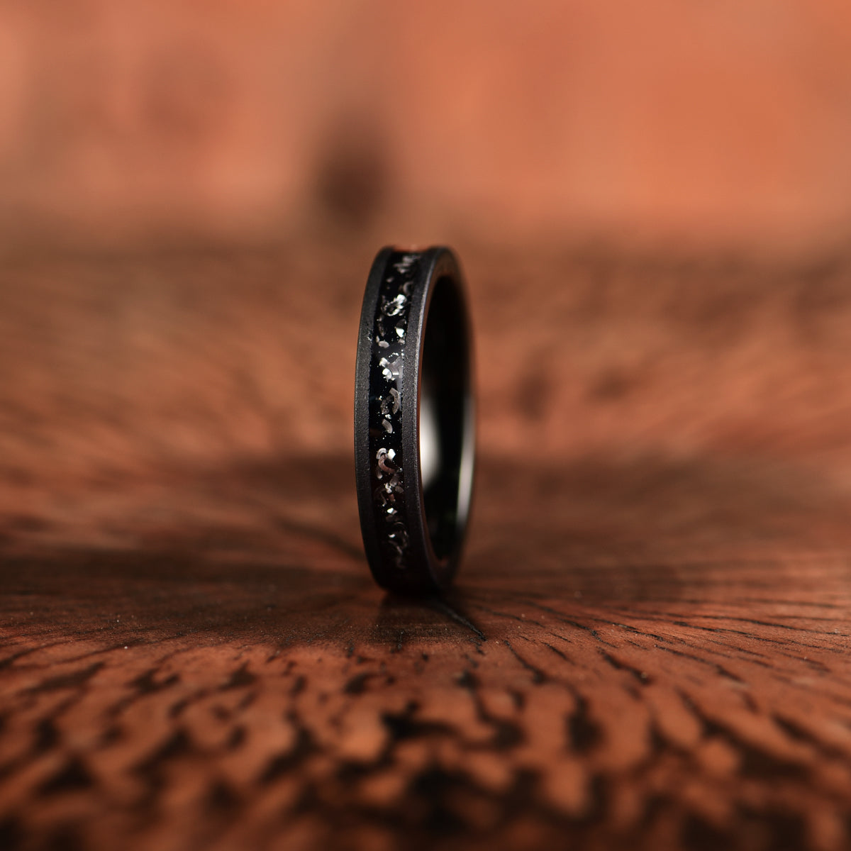 Crushed meteorite inlay sandblasted black tungsten men's wedding band 4mm facing front
